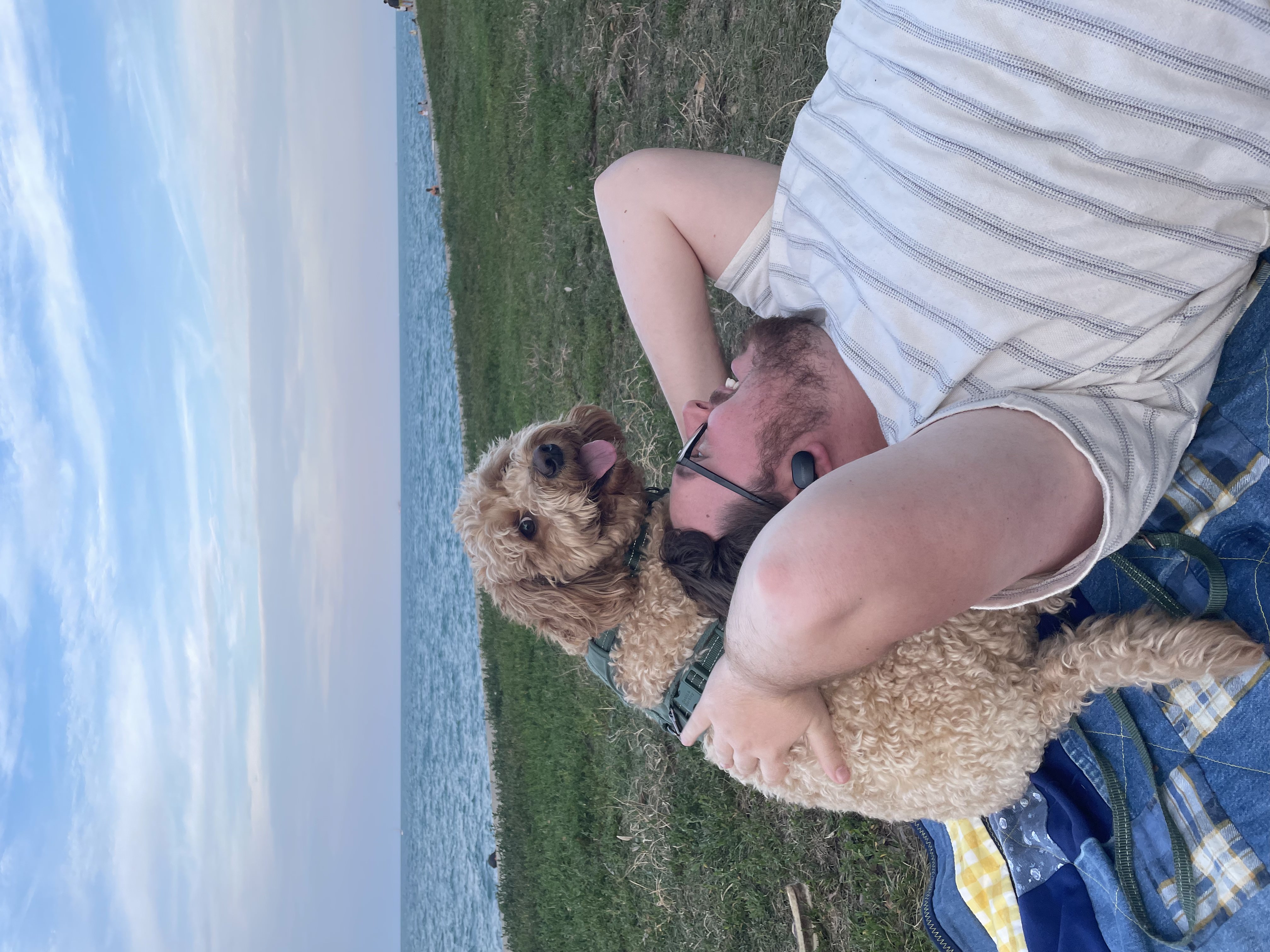 milo cuddles with dad at the park
